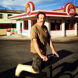 Man utilizes knee rover outdoors